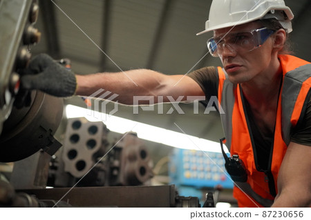 Industrial Engineers in Hard Hats.Work at the Heavy Industry Manufacturing Factory. 87230656