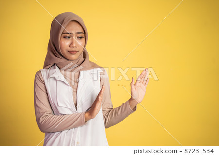 Young asian muslim woman refusing with both palms gesture 87231534