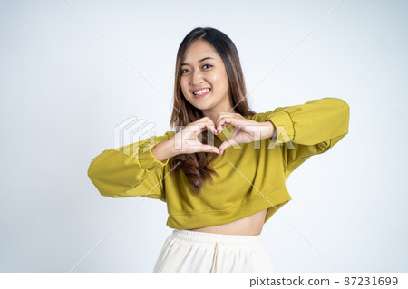young asian woman smiling in heart shape with fingers young asian woman smiling in heart shape with fingers 87231699