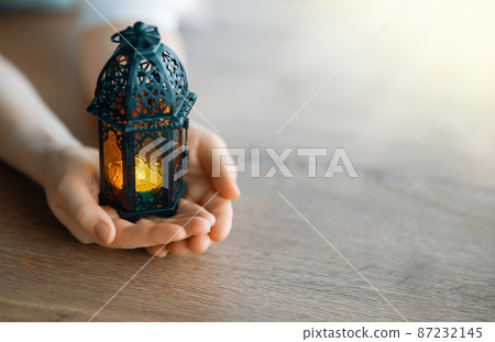 Ornamental Arabic lantern with burning candle 87232145