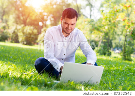Young businessman using laptop computer Young businessman using laptop computer 87232542