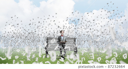 Young businessman or student studying the science and symbols fly around Young businessman or student studying the science and symbols fly around 87232664