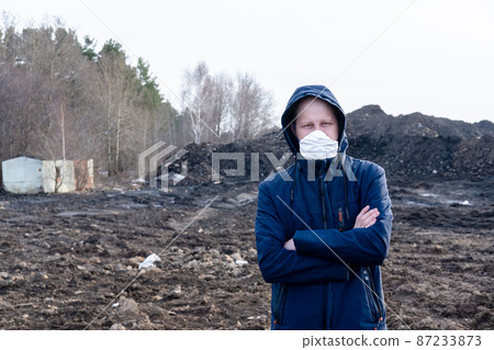 A man in a protective mask in an apocalyptic world. Environmental disaster. Dangerous toxic zone A man in a protective mask in an apocalyptic world. Environmental disaster. Dangerous toxic zone 87233873