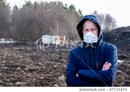 A man in a protective mask in an apocalyptic world. Environmental disaster. Dangerous toxic zone A man in a protective mask in an apocalyptic world. Environmental disaster. Dangerous toxic zone 87233874