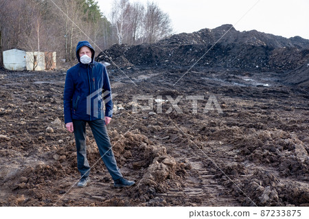 A man in a protective mask in an apocalyptic world. Environmental disaster. Dangerous toxic zone A man in a protective mask in an apocalyptic world. Environmental disaster. Dangerous toxic zone 87233875