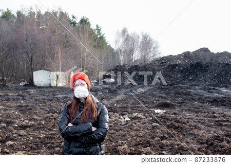 A girl in a protective mask in an apocalyptic world. Environmental disaster. Dangerous toxic zone A girl in a protective mask in an apocalyptic world. Environmental disaster. Dangerous toxic zone 87233876