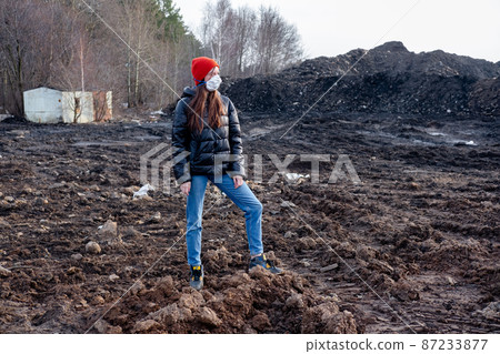 A girl in a protective mask in an apocalyptic world. Environmental disaster. Dangerous toxic zone A girl in a protective mask in an apocalyptic world. Environmental disaster. Dangerous toxic zone 87233877