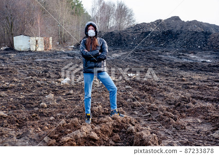 A girl in a protective mask in an apocalyptic world. Environmental disaster. Dangerous toxic zone A girl in a protective mask in an apocalyptic world. Environmental disaster. Dangerous toxic zone 87233878