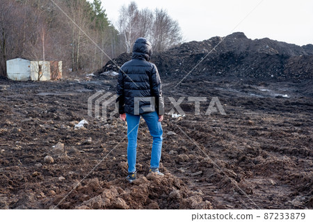 A girl in a protective mask in an apocalyptic world. Environmental disaster. Dangerous toxic zone A girl in a protective mask in an apocalyptic world. Environmental disaster. Dangerous toxic zone 87233879