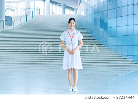 Smiling medical worker in white coat working in hospital 87234444