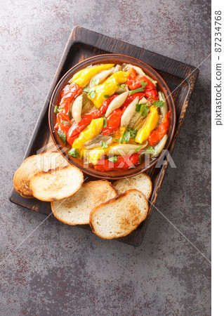 Escalivada or escalibada Spanish traditional dish of smoky grilled vegetables closeup in the wooden board. Vertical top view 87234768