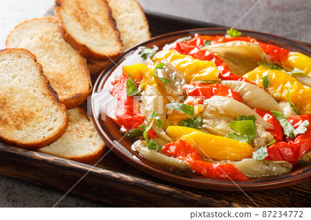 Escalivada Catalana or escalibada is a Spanish roasted vegetable dish closeup in the wooden board. Horizontal Escalivada Catalana or escalibada is a Spanish roasted vegetable dish closeup in the wooden board. Horizontal 87234772