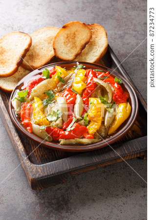 Escalivada or escalibada Spanish traditional dish of smoky grilled vegetables closeup in the wooden board. Vertical Escalivada or escalibada Spanish traditional dish of smoky grilled vegetables closeup in the wooden board. Vertical 87234773