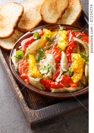 Escalivada Catalan Roasted Vegetables with toasts closeup in the wooden board. Vertical 87234774