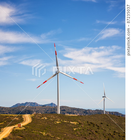 Turbines in a mountain wind farm. Ecological energy production. Turbines in a mountain wind farm. Ecological energy production. 87235037