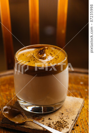 Dalgona coffee drink background. Korean coffee drink made with whipped instant coffee, sugar and milk. 87235998