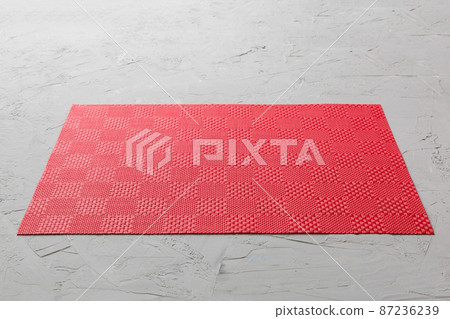 Perspective view of red tablecloth for food on cement background. Empty space for your design 87236239