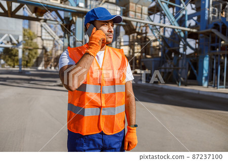 Photo of man working hard at construction industry plant Photo of man working hard at construction industry plant 87237100