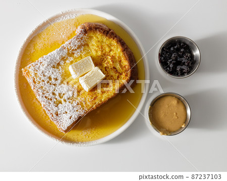 Butter melting on fresh piece of bread Butter melting on fresh piece of bread 87237103