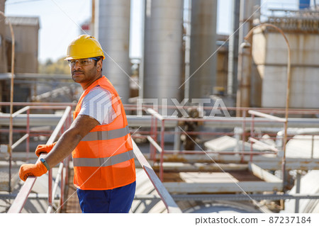 Experienced worker concentrating at his work in plant Experienced worker concentrating at his work in plant 87237184