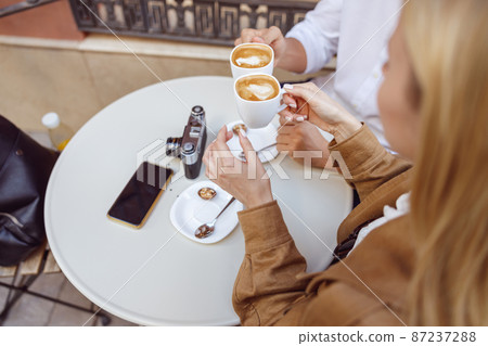 Close-up photo of lady and male drinking coffee Close-up photo of lady and male drinking coffee 87237288