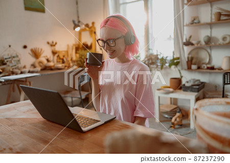Business woman works at her pottery store Business woman works at her pottery store 87237290