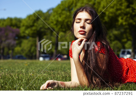 pretty young woman in red dress smiling cheerful in green park on summer sunny day, lifestyle people concept pretty young woman in red dress smiling cheerful in green park on summer sunny day, lifestyle people concept 87237291