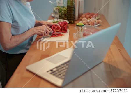 Photo of aged lady making breakfast at home Photo of aged lady making breakfast at home 87237411