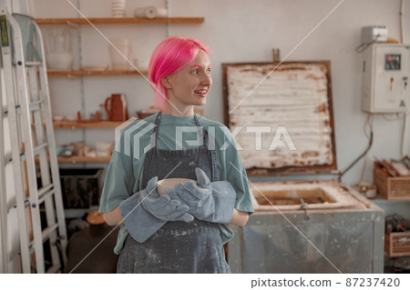 Cute ceramist working with pottery at ceramic workshop Cute ceramist working with pottery at ceramic workshop 87237420