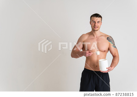 Fitness protein jars white on white background bodybuilder powder strong high back hurt painful, cramp sick man massage stress, holding. Tension red sickness, disease suffer attractive 87238815