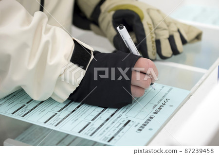 Men filling out the ski snowboard rental form Men filling out the ski snowboard rental form 87239458