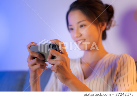A woman relaxing at home at night A woman relaxing at home at night 87242173