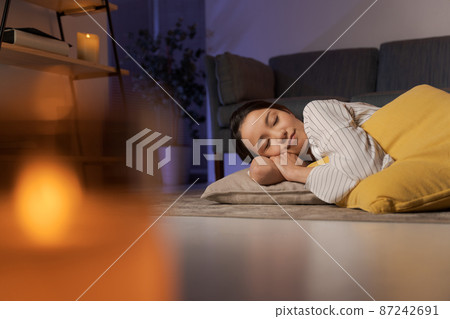 A woman relaxing at home at night 87242691