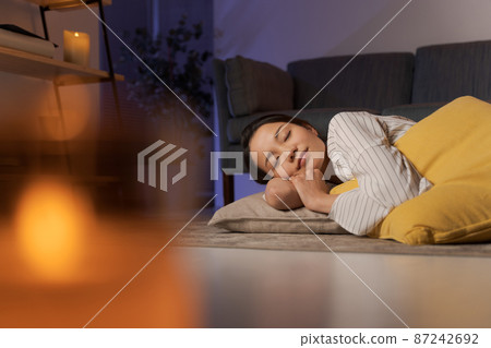 A woman relaxing at home at night 87242692