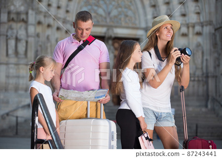 Family with children using camera and map in Europe city Family with children using camera and map in Europe city 87243441