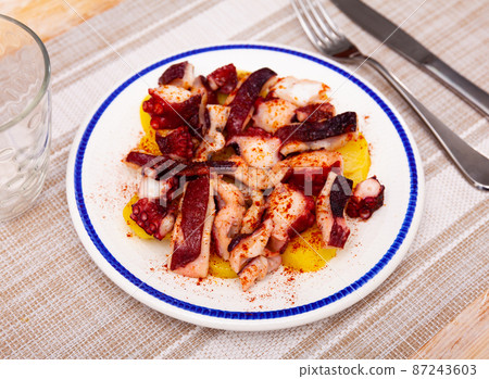 Pulpo a la gallega on plate 87243603
