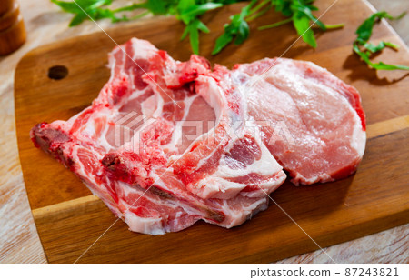 Fresh raw pork loin chops with condiments 87243821