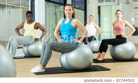 Sporty people training pilates at group class 87244502