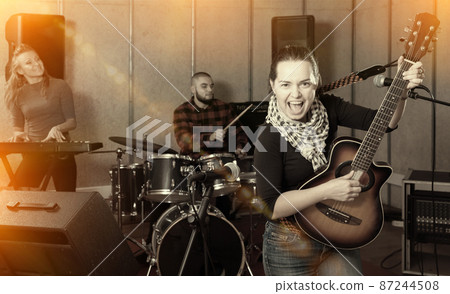 Young guitar player and singer with band Young guitar player and singer with band 87244508