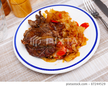 Portion of pork meat with stewed cabbage Portion of pork meat with stewed cabbage 87244529