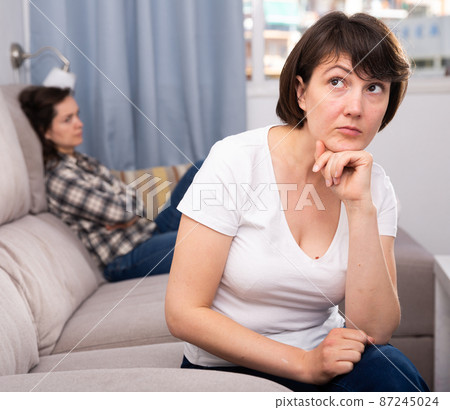 Upset adult woman after conflict with young sister at home interior 87245024