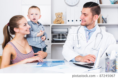 Adult male doctor leading medical appointment Adult male doctor leading medical appointment 87245067