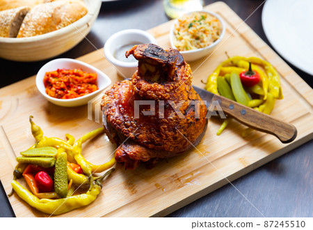 Roasted Ham Hock with pickled vegetables on wooden tray Roasted Ham Hock with pickled vegetables on wooden tray 87245510