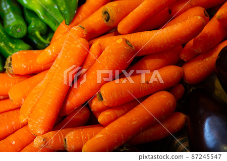 Bunch of juicy carrots in crate 87245547