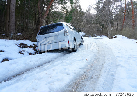 Car trouble on a forest road in winter. Derailment / fall 87245620