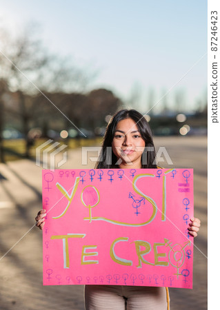 8 march feminism movement. Ecuadorian young woman with a Spanish banner. yo si te creo 87246423