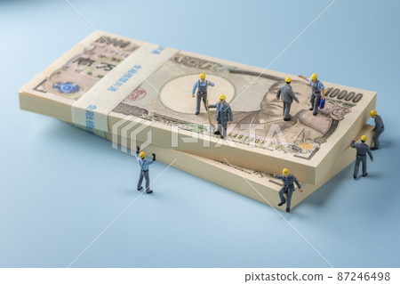 Money (wad of bills) and miniature workers Money (wad of bills) and miniature workers 87246498