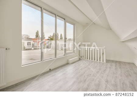 an empty room in the upper floor with the door entering to the balcony an empty room in the upper floor with the door entering to the balcony 87248152