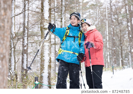 Couple enjoying snowshoes 87248785