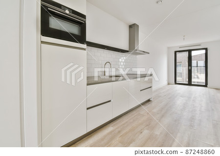 interior of modern kitchen room with doors entering to the balcony interior of modern kitchen room with doors entering to the balcony 87248860